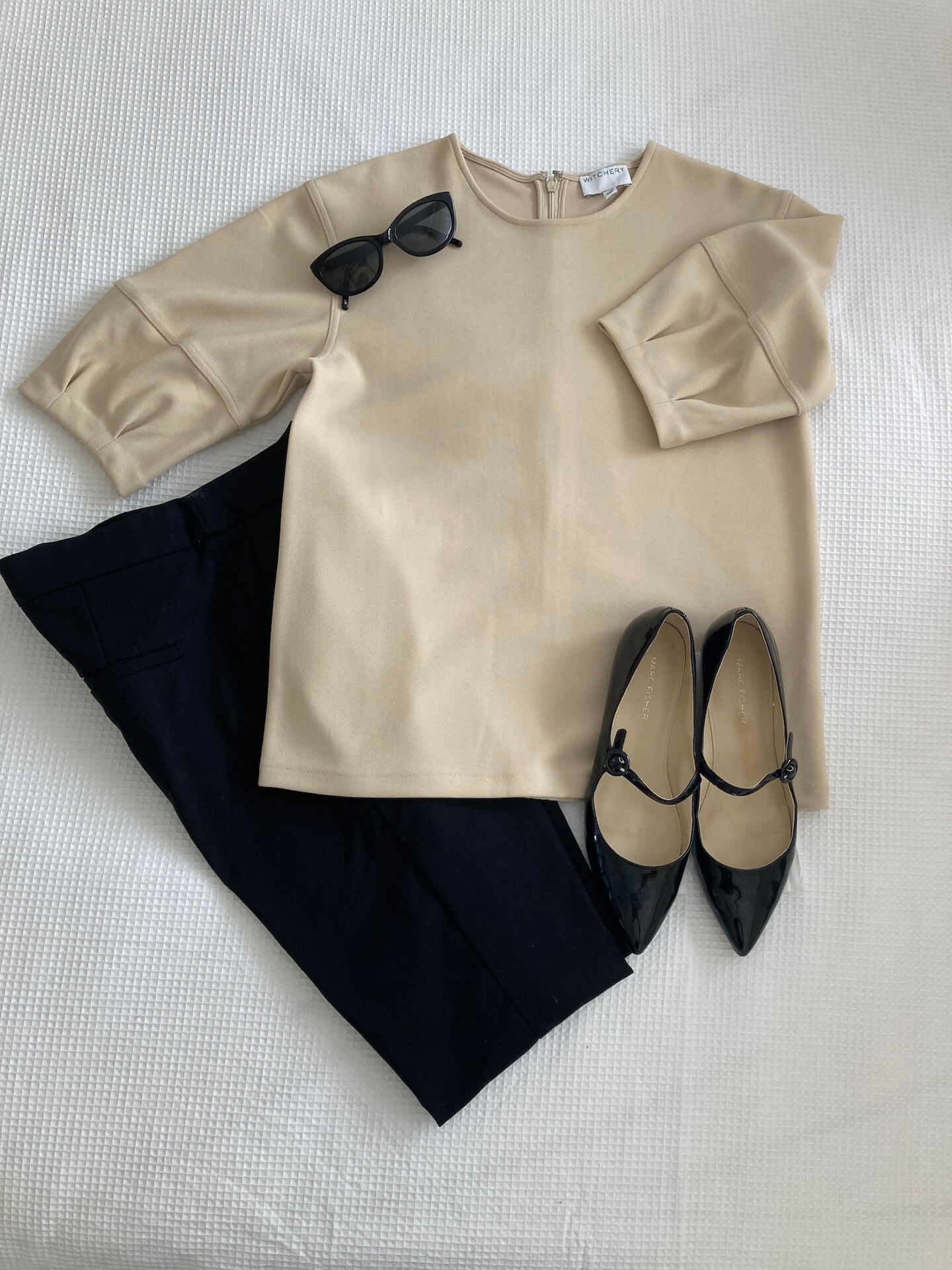 beige top and black pants