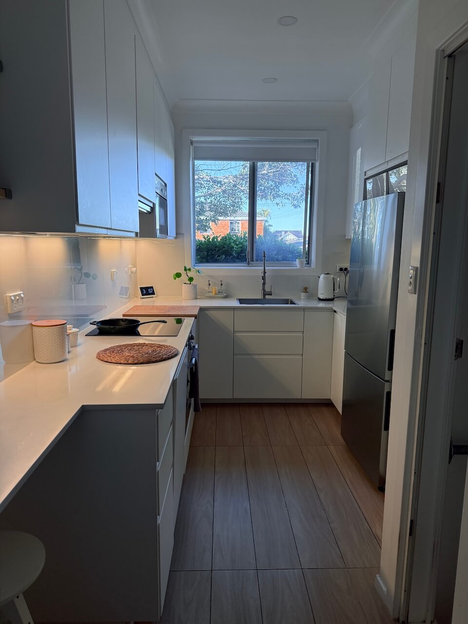 My favourite room in the house, our white kitchen with galley layout and large windows