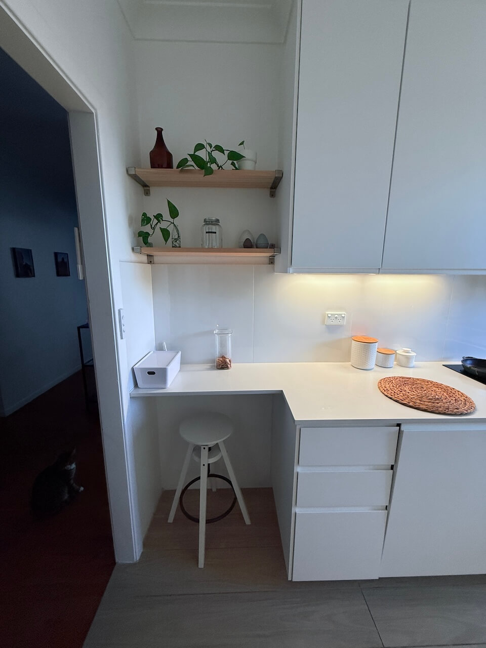 Kitchen nook in my favourite room in the house with stool, open shelves and plants