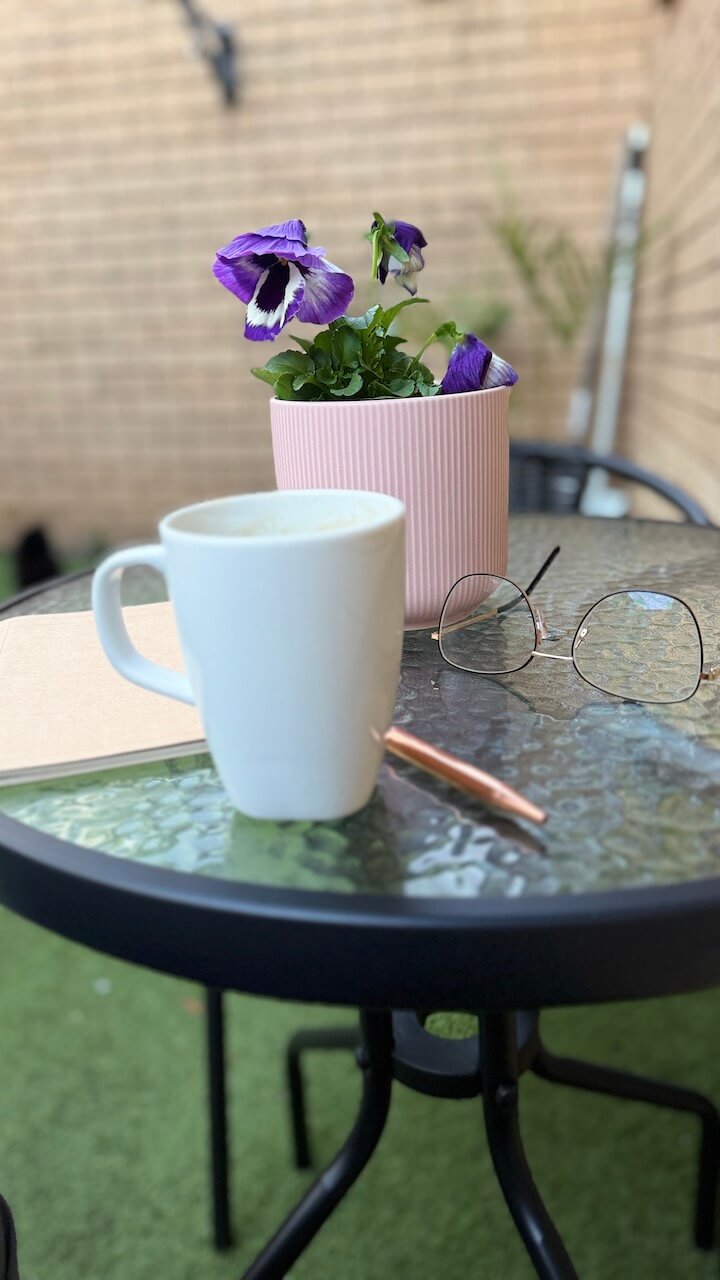 what's up Wednesday–Coffee cup and potted plant in the courtyard